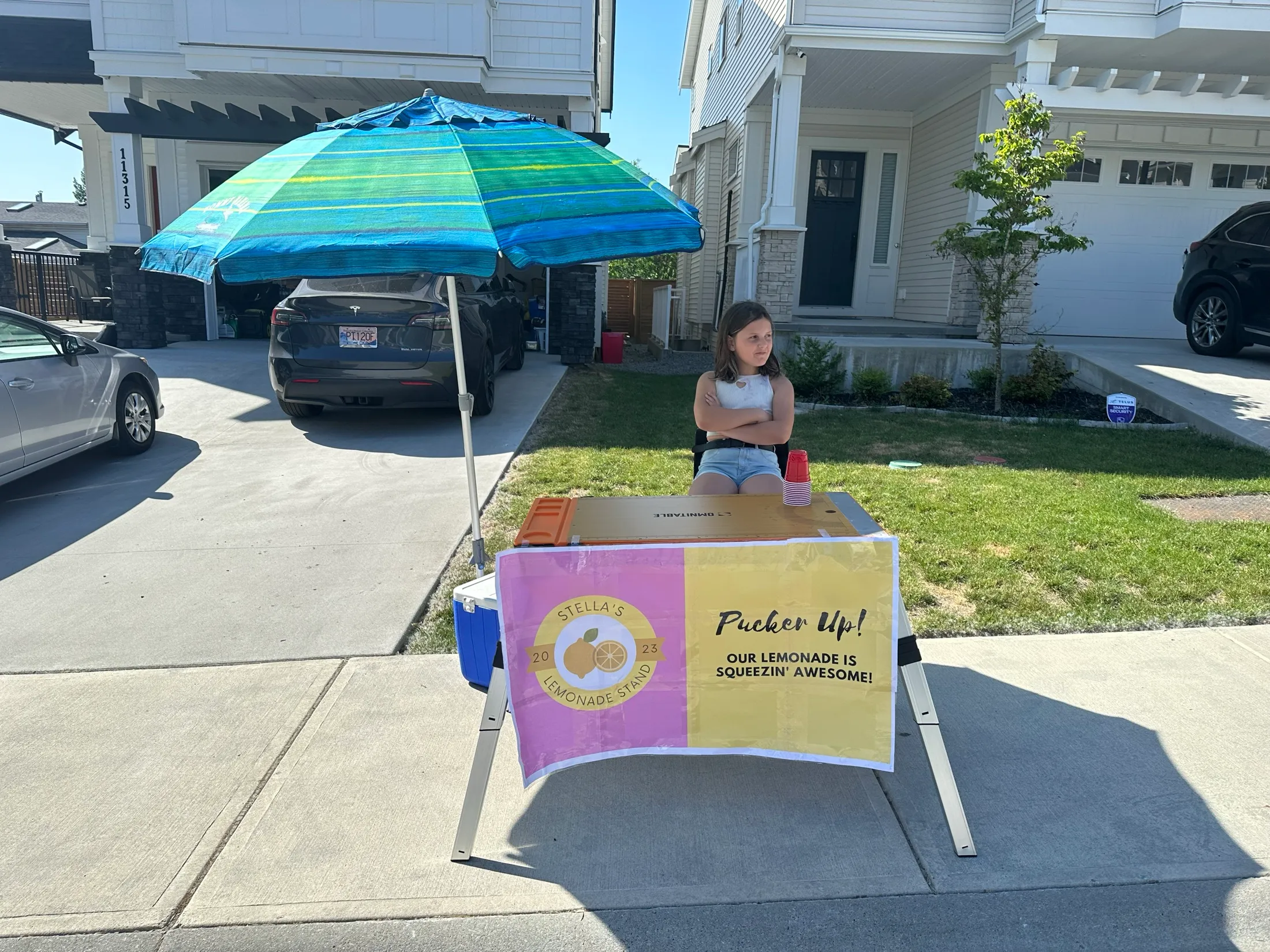 Stella with arms crossed, thinking, at the opening-day stand.
